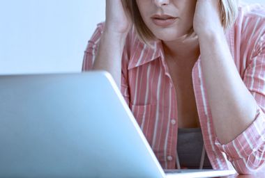 Woman stressed at laptop