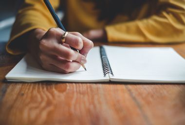 Close up woman hand writing on notebook