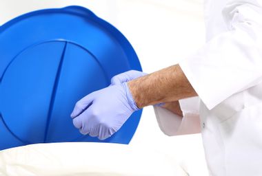 Medical waste, surgeon dropping the gloves in a special container