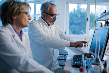 Scientists doing research on desktop PC in a laboratory