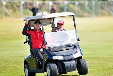 President Donald Trump driving a golf cart
