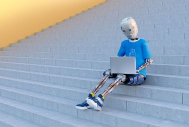 Robot sitting on stairs using laptop