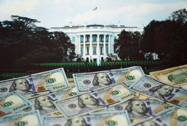 U.S. dollar banknotes and an image of White House