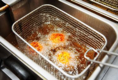 Deep frying food in restaurant kitchen