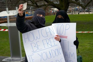 Two Muslim women wearing the niqab take a selfie during the demonstration