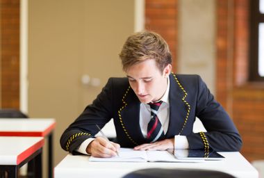 High school boy in uniform in classroom