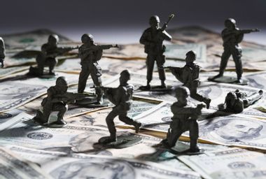 Toy soldier fighting on money