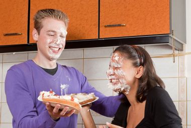 Funny pie fight between a young couple