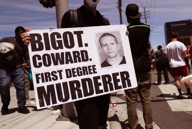 A protester holds a sign with a photo of former Minneapolis police officer Derek Chauvin