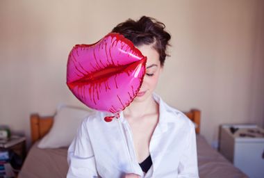 Young woman with lips-shaped balloon