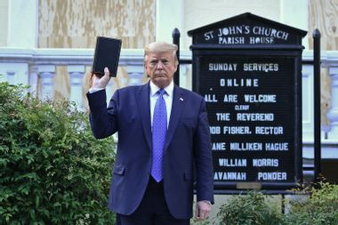 US President Donald Trump holds up a Bible