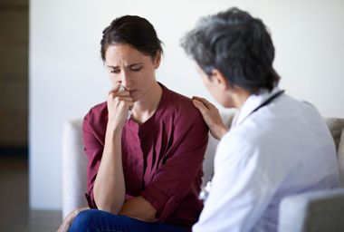 Doctor talking to distressed patient