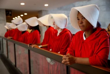 Protesters dressed in The Handmaid's Tale costume