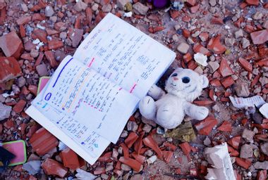 A toy and a notebook lies among the debris by the apartment block in 6A Lobanovsky Avenue which was hit with a missile on February 26, 2022 in Kyiv, Ukraine