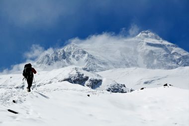 Man climbing up mountain at Mt. Everest