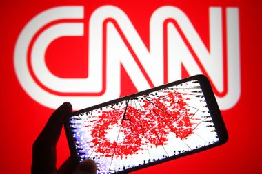 CNN logo distorted on cracked phone screen