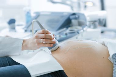 Doctor Doing Ultrasound / Sonogram Scan to a Pregnant Woman