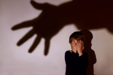 A little boy and scary shadow of hand