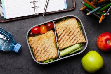 Healthy lunch box with sandwich and vegetables