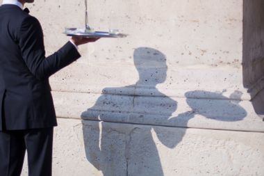 Waiter's shadow at cafe