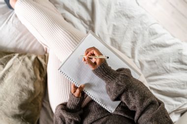 Woman writing in bed