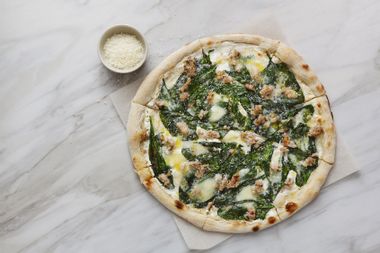 Pizza with chopped meat, spinach and cream sauce