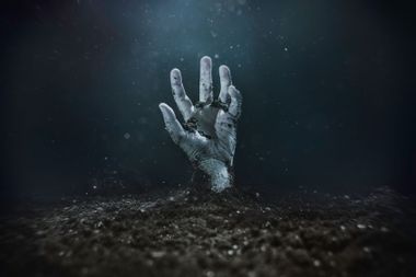 Zombie hand emerging from the ground