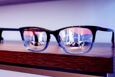 Prisoner's reflected in glasses on a shelf