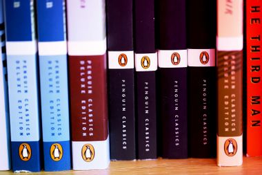 The Penguin logo is visible on the spines of books displayed on a shelf