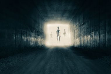 Aliens emerging from the light at the end of a tunnel
