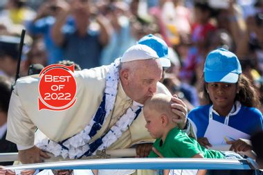 Pope Francis kisses a child