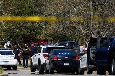 Police work near the scene of a mass shooting at the Covenant School