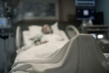 Sick woman lying in the hospital bed