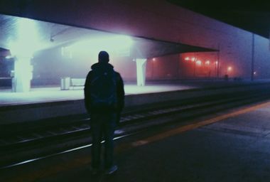Man alone at a train station at night