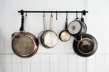 Pots and pans hanging on a kitchen wall