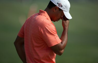 Tiger Woods of the U.S. reacts after taking a shot on the 14th hole during the 2009 HSBC Champions golf tournament in Shanghai