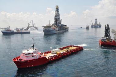 Ships and drilling rigs surround the Discoverer Enterprise as it continues to recover oil from the Deepwater Horizon drill site in the Gulf of Mexico