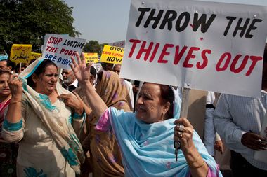 Pakistan's opposition lawmakers rally outside the parliament in Islamabad, Pakistan, Thursday, Oct, 6. 2011