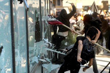 A small group of Occupy Oakland protesters smash windows