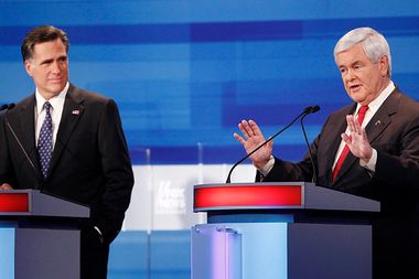 Republican presidential candidate former Massachusetts Governor Mitt Romney (L) looks on as former U.S. Speaker of the House Newt Gingrich (R-GA) speaks during the Republican Party presidential candidates debate in Sioux City, Iowa, December 15, 2011.