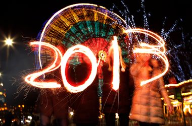 Revellers write 2013 using sparklers during the Hogmanay street party celebrations in Edinburgh, Scotland