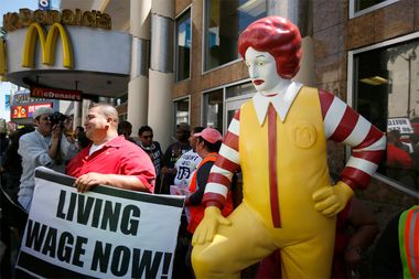 Striking McDonald's worker Bartolome Perez, 42, protests outside McDonald's on Hollywood Boulevard as part of a nationwide strike by fast-food workers to call for wages of $15 an hour, in Los Angeles