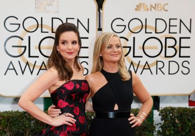 Tina Fey and Amy Poehler arrive at the 71st annual Golden Globe Awards in Beverly Hills