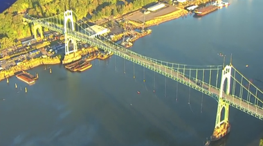 Protestors dangle from bridge