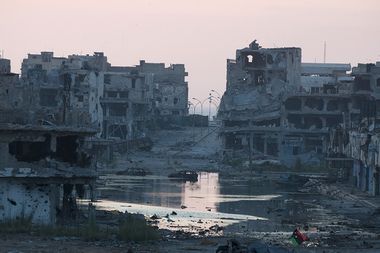 Damaged homes are seen after clashes between members of the Libyan pro-government forces, backed by the locals, and Shura Council of Libyan Revolutionaries in Benghazi