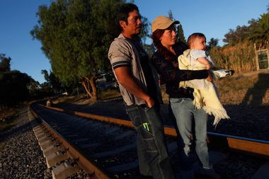 An illegal Salvadoran migrant couple is seen on railway track with their son Andrew, six months, during the arrival of the "Caravana de Madres Centroamericanas" to Huehuetoca