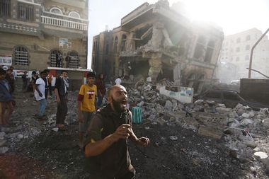 Man reacts at the site of a Saudi-led air strike in Yemen's capital Sanaa