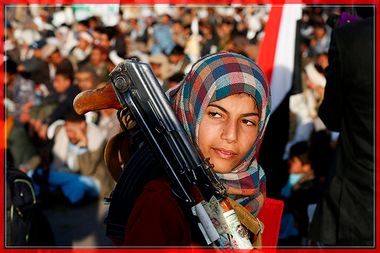 A girl carries a rifle as she attends a rally by followers of the Shi'ite Houthi movement commemorating the death of Imam Zaid bin Ali in Sanaa, Yemen