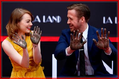 Actors Stone and Gosling show their hands after placing them in cement during a ceremony in the forecourt of the TCL Chinese theatre in Hollywood