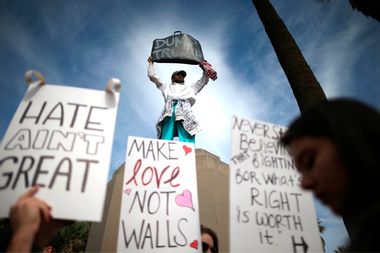 People hold signs during a march and rally against the election of Republican Donald Trump as President of the United States in Los Angeles